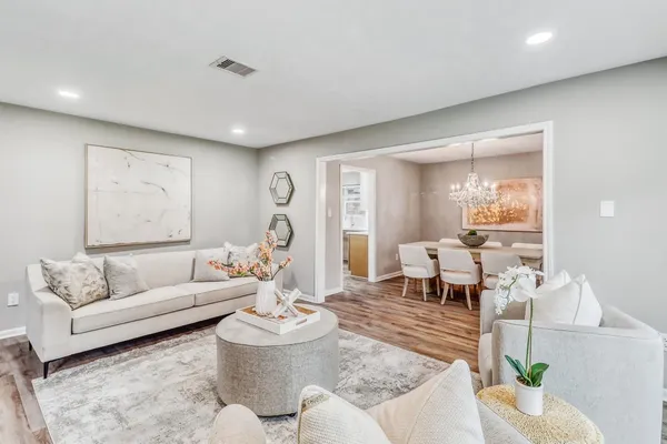 a living room with furniture and wooden floor