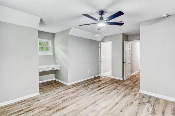 a view of room with window and wooden floor