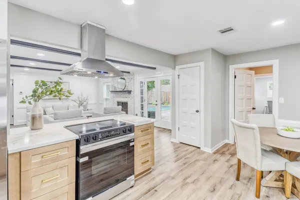 a kitchen with stainless steel appliances a stove a sink and a refrigerator