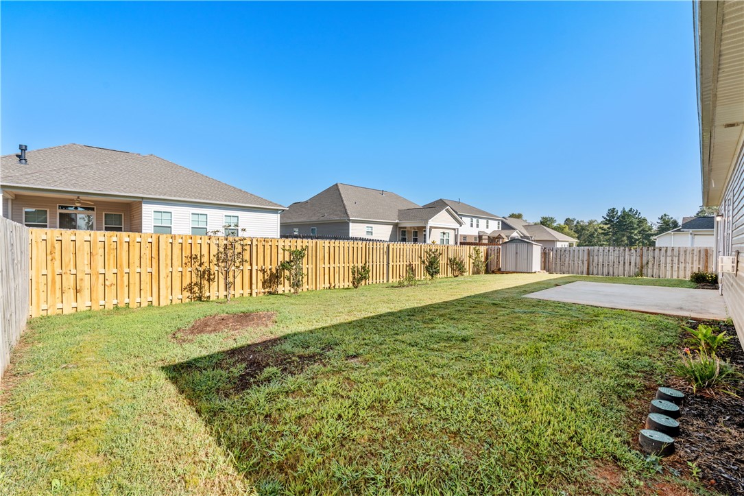 127 Spyglass Lane Pendleton, SC 29670 - Photo 33 of 45 A spacious grassy lawn is enclosed by a tall wooden privacy fence.