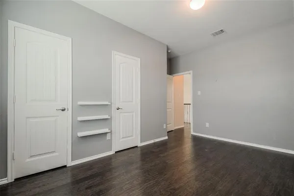 a view of an empty room with a closet
