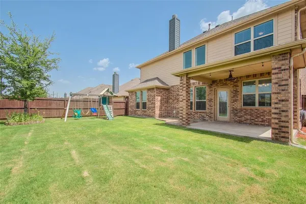 a view of a house with backyard and porch