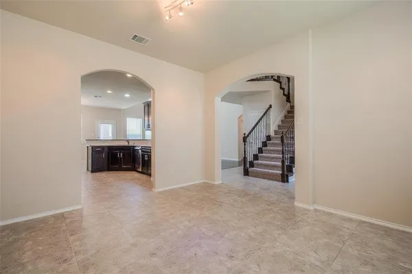 an empty room with windows and entryway