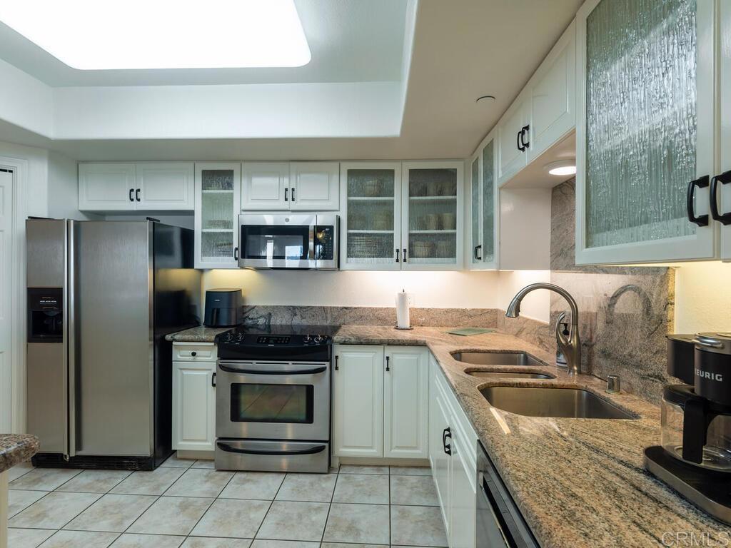 1099 1st Street, Unit 217 Coronado, CA 92118 - Photo 16 of 32 a kitchen with stainless steel appliances granite countertop a stove and a refrigerator