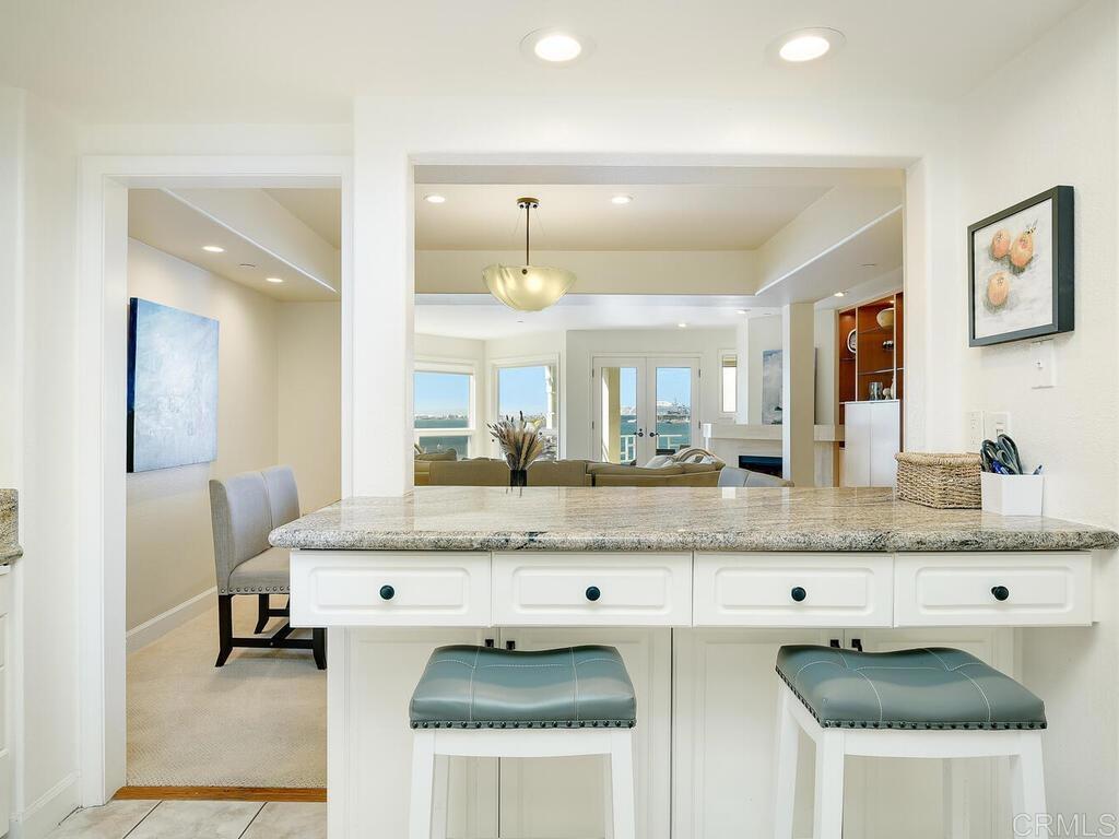 1099 1st Street, Unit 217 Coronado, CA 92118 - Photo 18 of 32 a bathroom with a granite countertop sink and a mirror