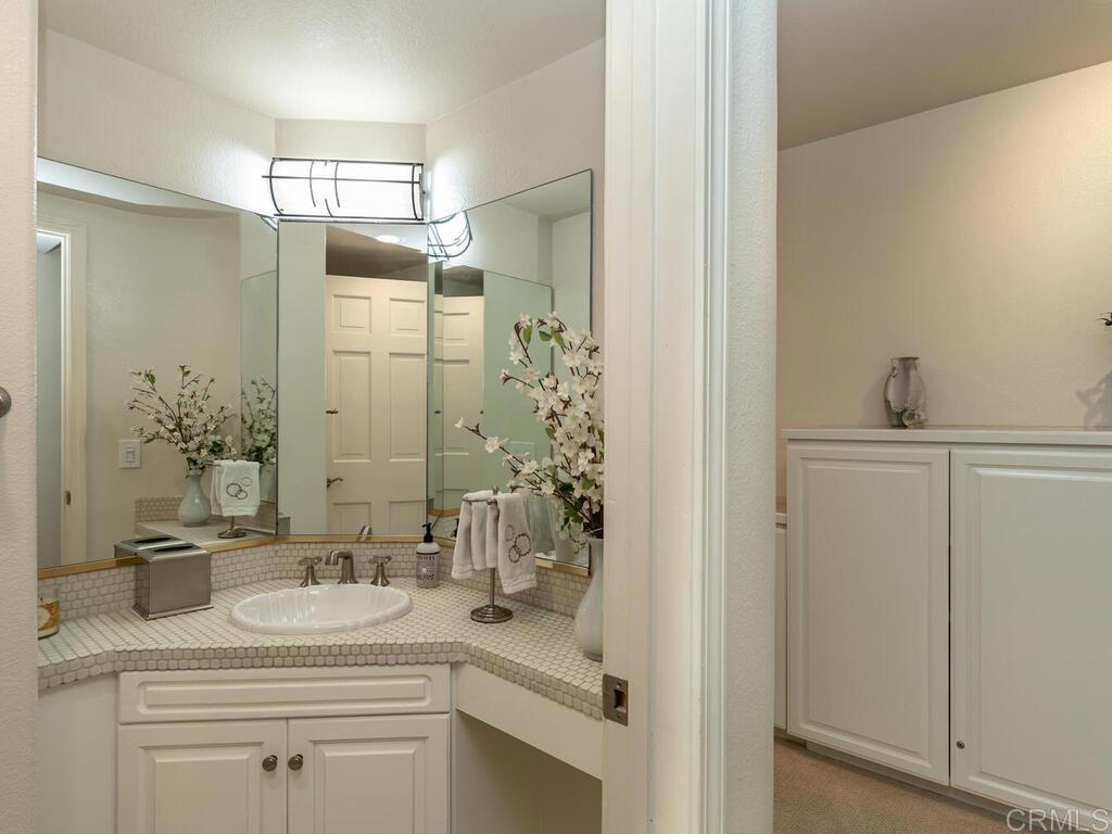 1099 1st Street, Unit 217 Coronado, CA 92118 - Photo 20 of 32 a bathroom with a sink and a mirror