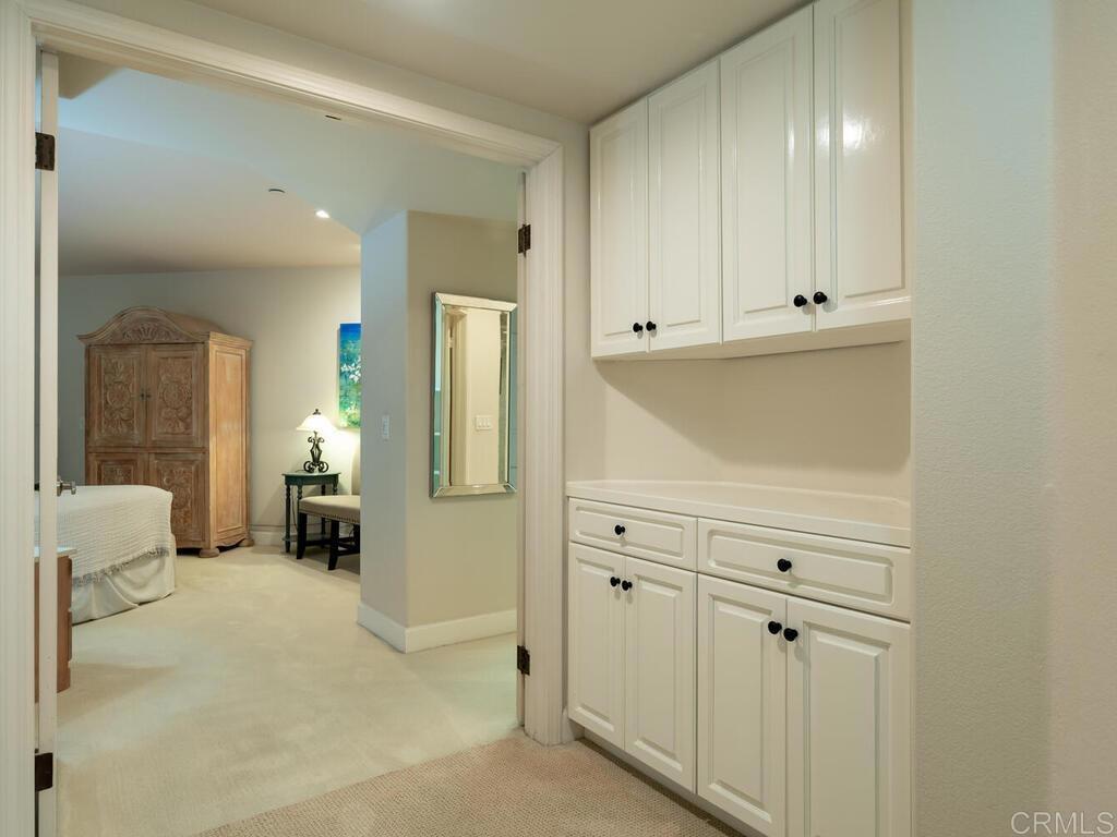 1099 1st Street, Unit 217 Coronado, CA 92118 - Photo 21 of 32 a view of a hallway with closet and a couch