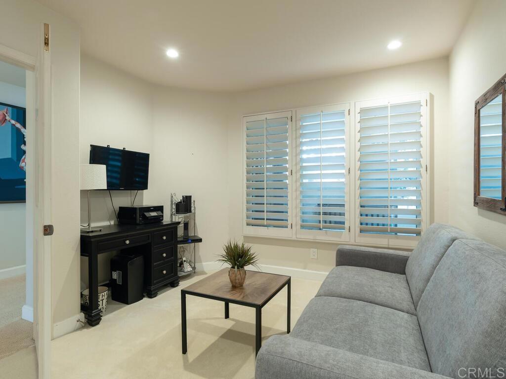 1099 1st Street, Unit 217 Coronado, CA 92118 - Photo 27 of 32 a living room with furniture and a flat screen tv