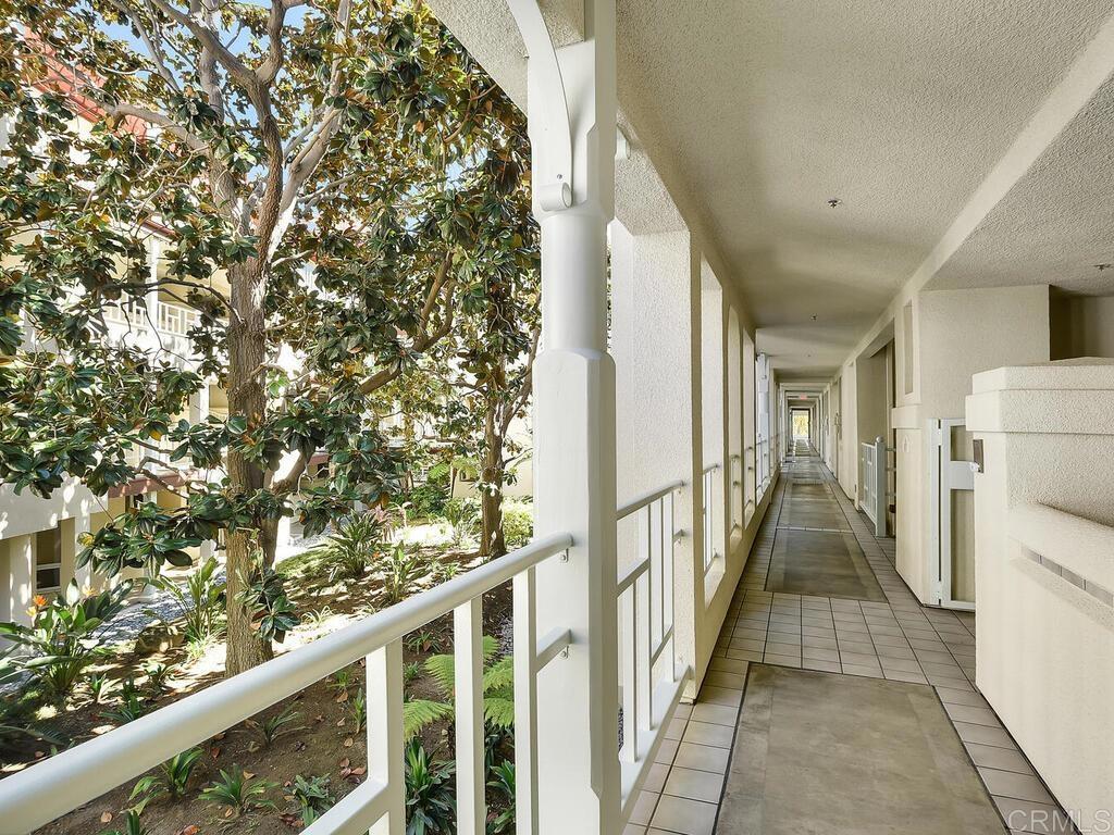1099 1st Street, Unit 217 Coronado, CA 92118 - Photo 29 of 32 a view of a hallway with wooden walls and stairs