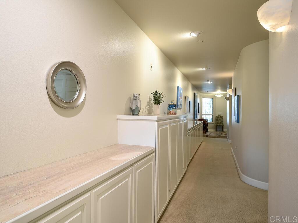 1099 1st Street, Unit 217 Coronado, CA 92118 - Photo 7 of 32 a view of a kitchen with a sink and a refrigerator