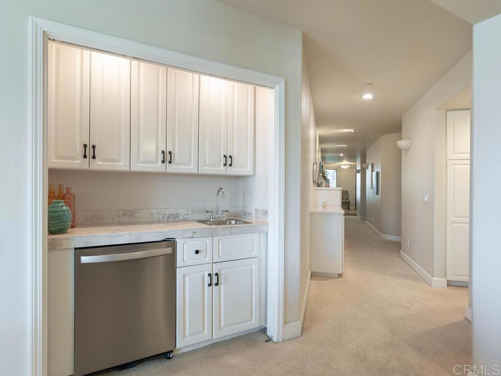 1099 1st Street, Unit 217 Coronado, CA 92118 - Photo 8 of 32 a view of a kitchen with white cabinets