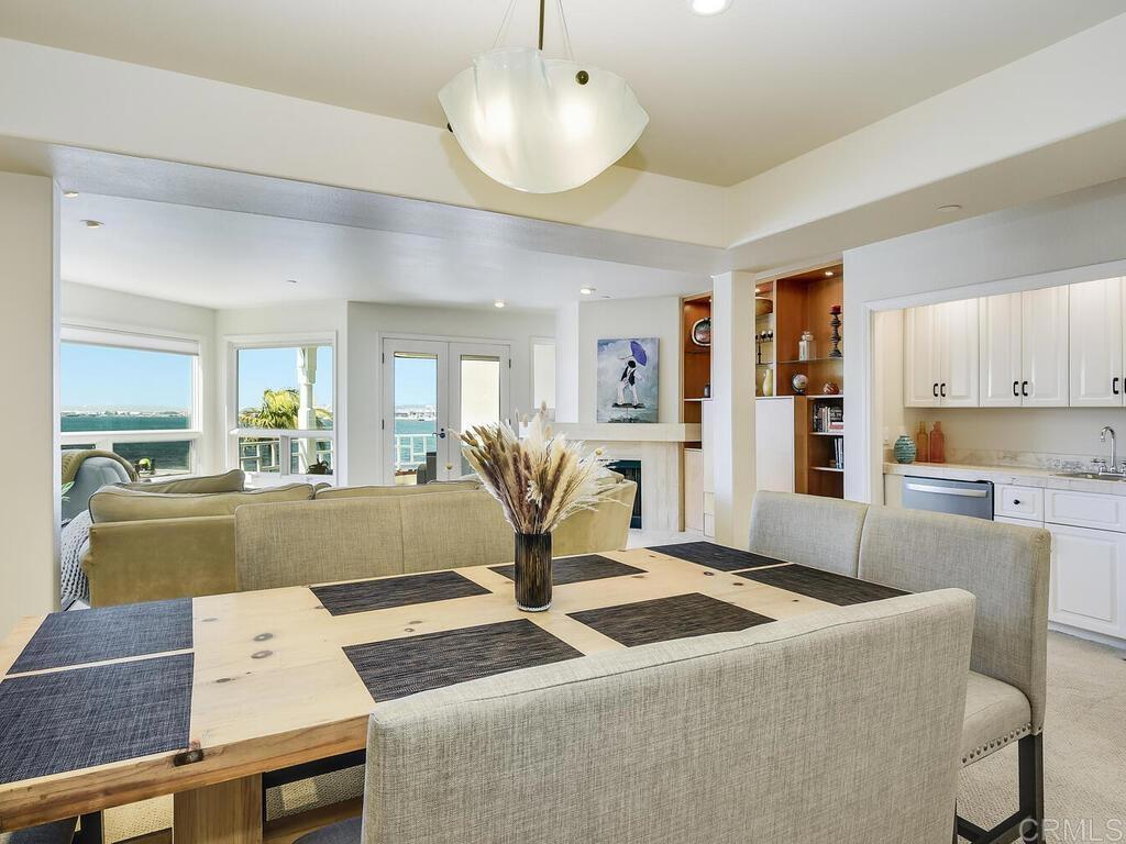1099 1st Street, Unit 217 Coronado, CA 92118 - Photo 10 of 32 a living room with kitchen island furniture and a chandelier