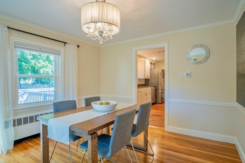3 Elliot Road Lynnfield, MA 01940 - Photo 11 of 42 a view of a dining room with furniture a chandelier and wooden floor