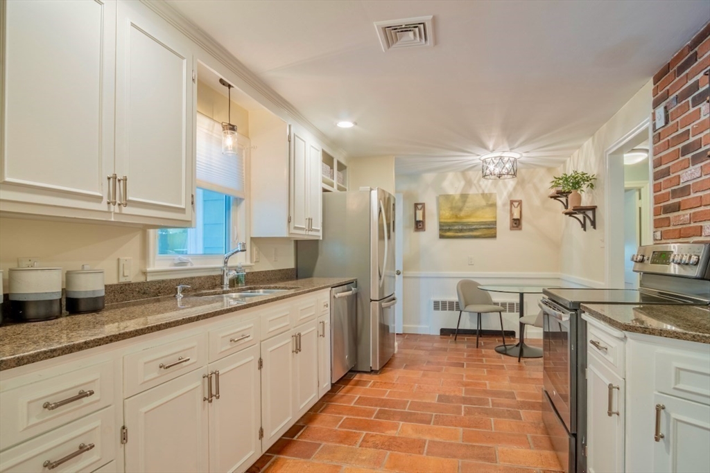 3 Elliot Road Lynnfield, MA 01940 - Photo 12 of 42 a large white kitchen with stainless steel appliances granite countertop a sink and dishwasher a oven with white cabinets