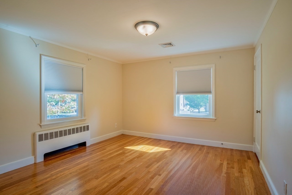 3 Elliot Road Lynnfield, MA 01940 - Photo 23 of 42 a view of an empty room with wooden floor and a window
