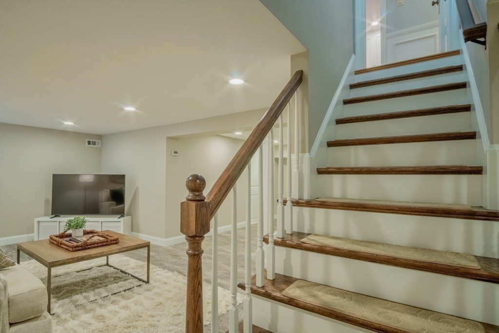 3 Elliot Road Lynnfield, MA 01940 - Photo 25 of 42 a living room with furniture and a flat screen tv