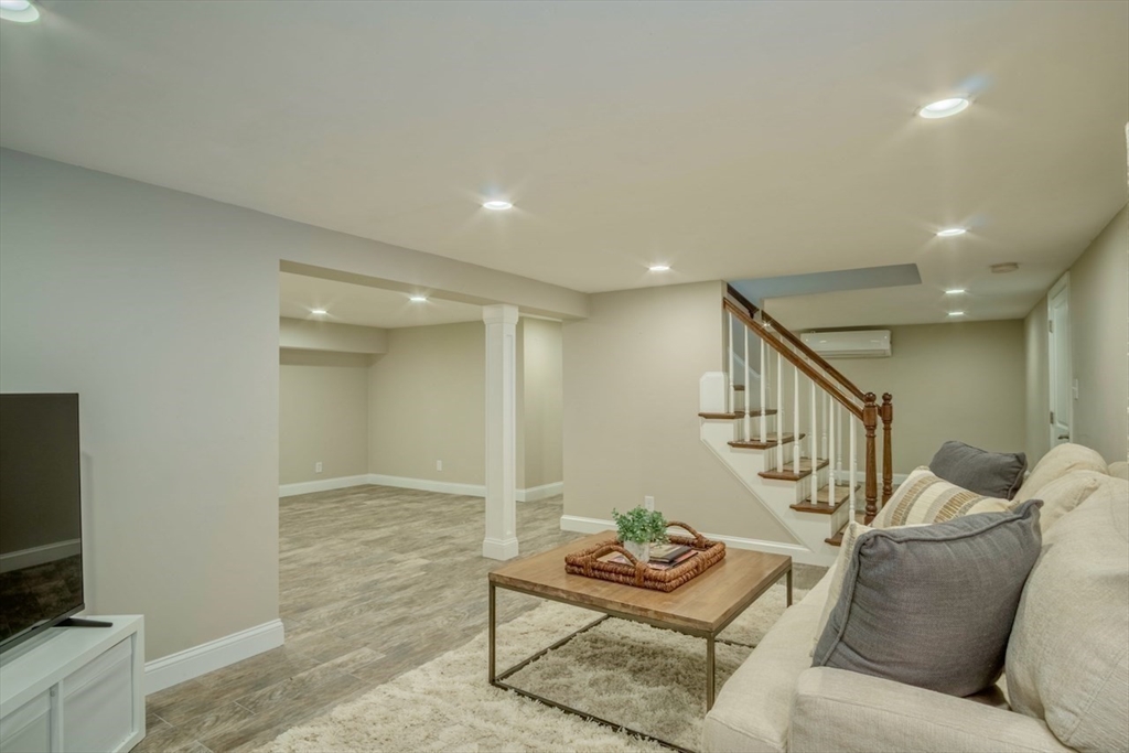 3 Elliot Road Lynnfield, MA 01940 - Photo 27 of 42 a living room with furniture and a flat screen tv