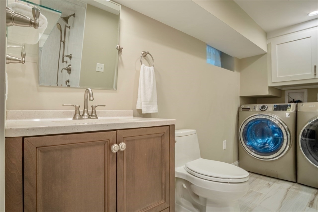 3 Elliot Road Lynnfield, MA 01940 - Photo 34 of 42 a bathroom with a toilet sink vanity and mirror