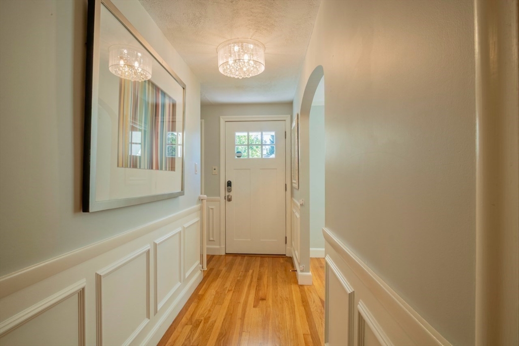 3 Elliot Road Lynnfield, MA 01940 - Photo 4 of 42 a view of a hallway with wooden floor and staircase