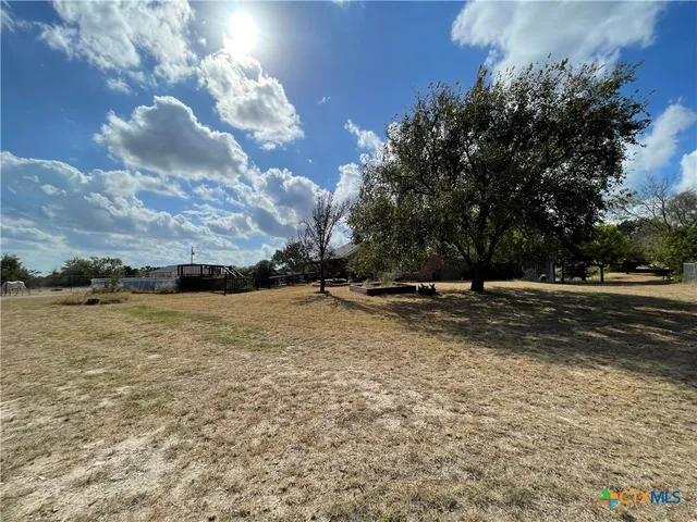 a living room with furniture a chandelier and a large window
