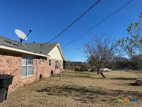 a roof deck with table and chairs and potted plants