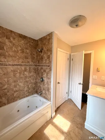a bathroom with a bathtub and a shower