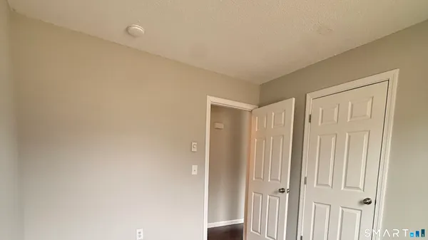 a view of a livingroom with wooden floor and entryway