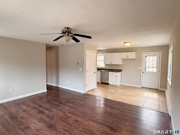 a view of a kitchen with wooden floor and a kitchen