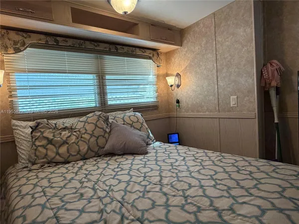 a bedroom with a bed and a window
