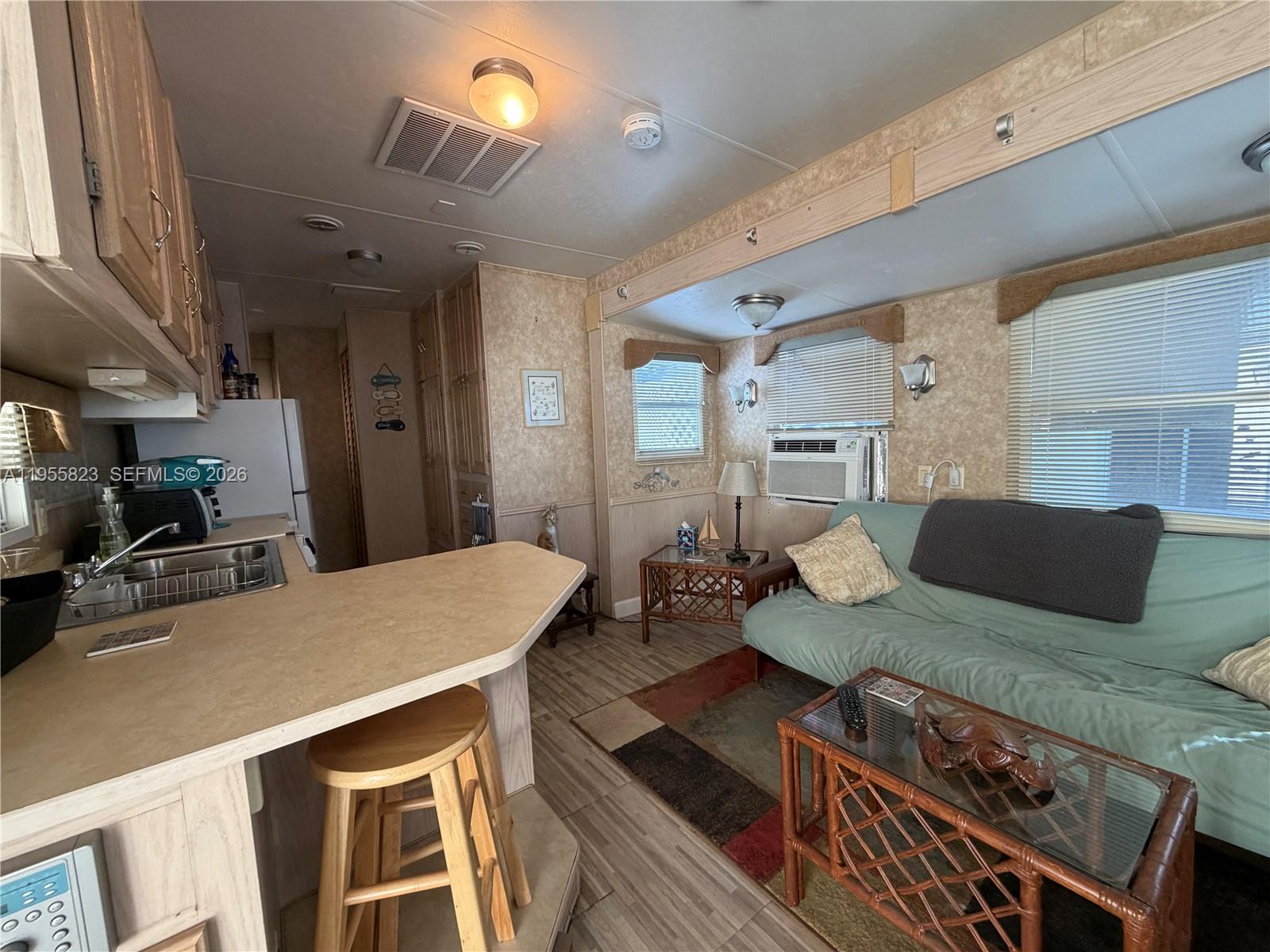 1361 Overseas Highway Marathon, FL 33050 - Photo 7 of 12 a living room with furniture and a flat screen tv
