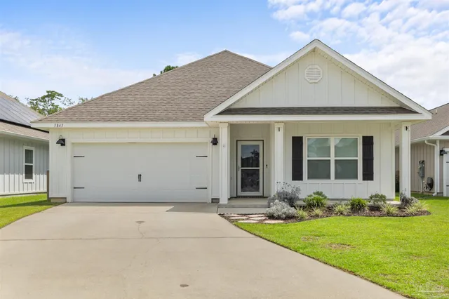 a view of a yard in front of a house with plants