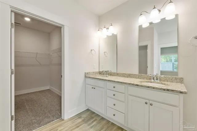 a bathroom with a double vanity sink and a mirror