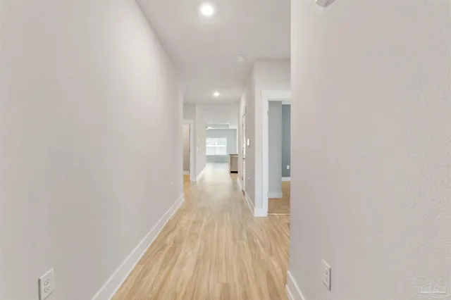 a view of a room with wooden floor and a bathroom