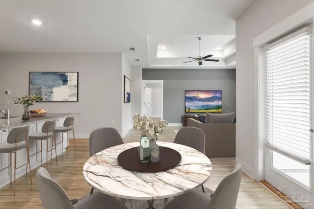 a dining room with furniture and a chandelier