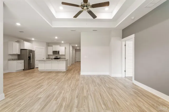 a view of kitchen with cabinets and wooden floor