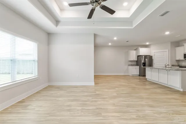 a view of kitchen with refrigerator and window