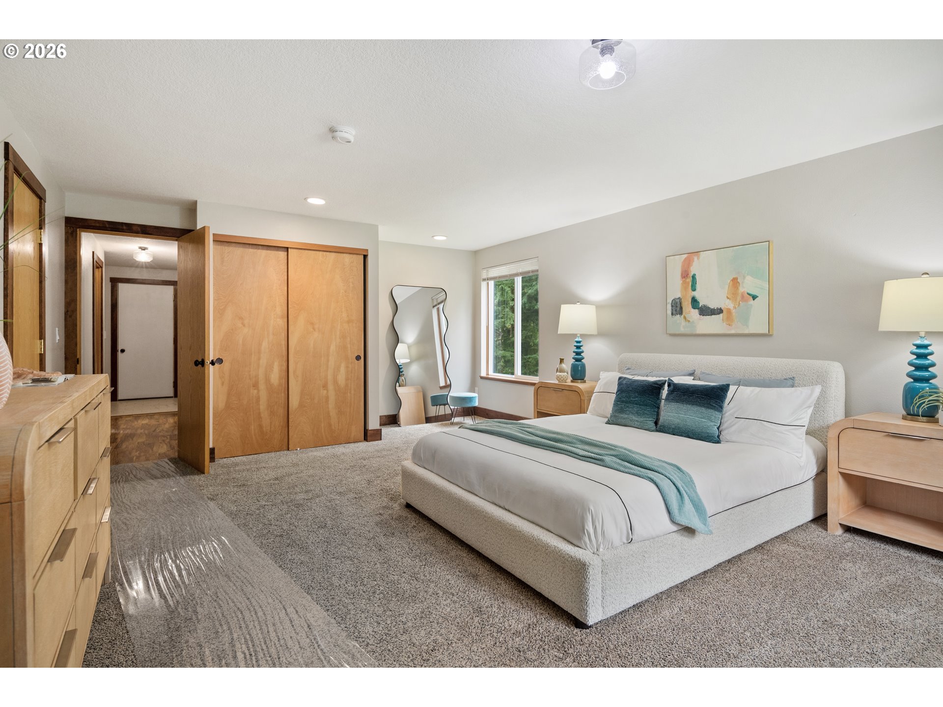 650 Marvin Road Tillamook, OR 97141 - Photo 23 of 48 a spacious bedroom with a large bed and a chandelier