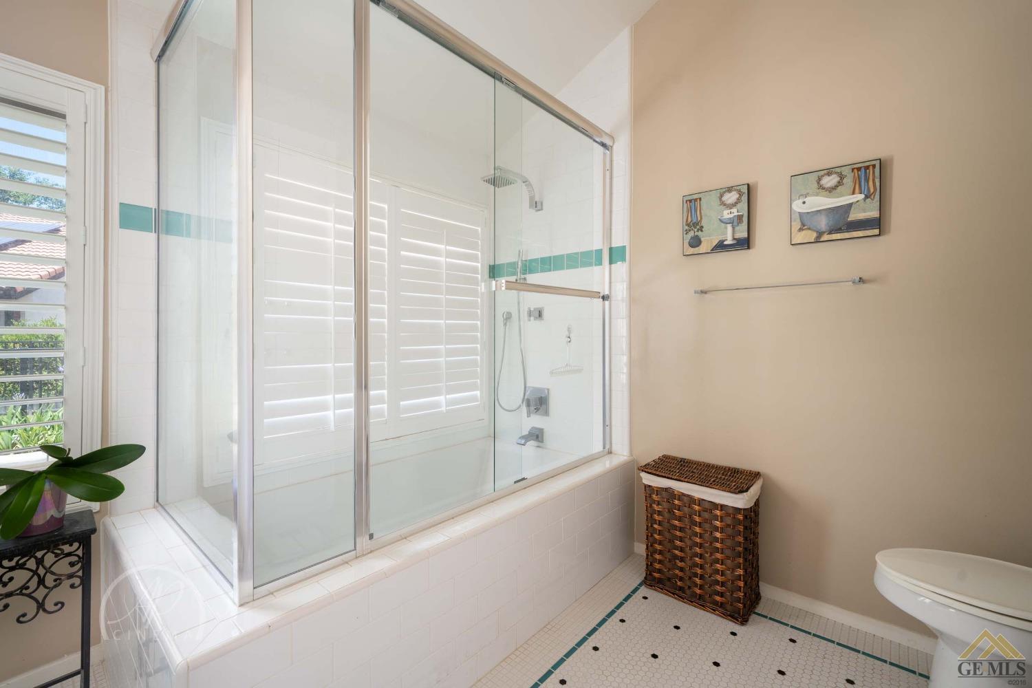 Undisclosed Address Bakersfield, CA 93309 - Photo 17 of 26 a bathroom with a bathtub and a shower