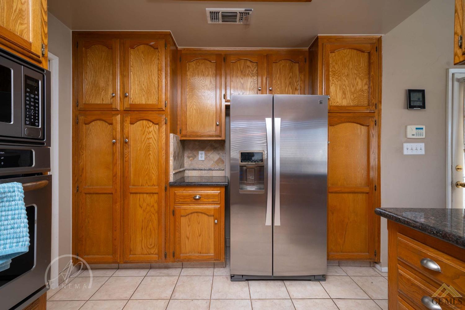 Undisclosed Address Bakersfield, CA 93309 - Photo 21 of 26 a metallic refrigerator freezer sitting in a kitchen