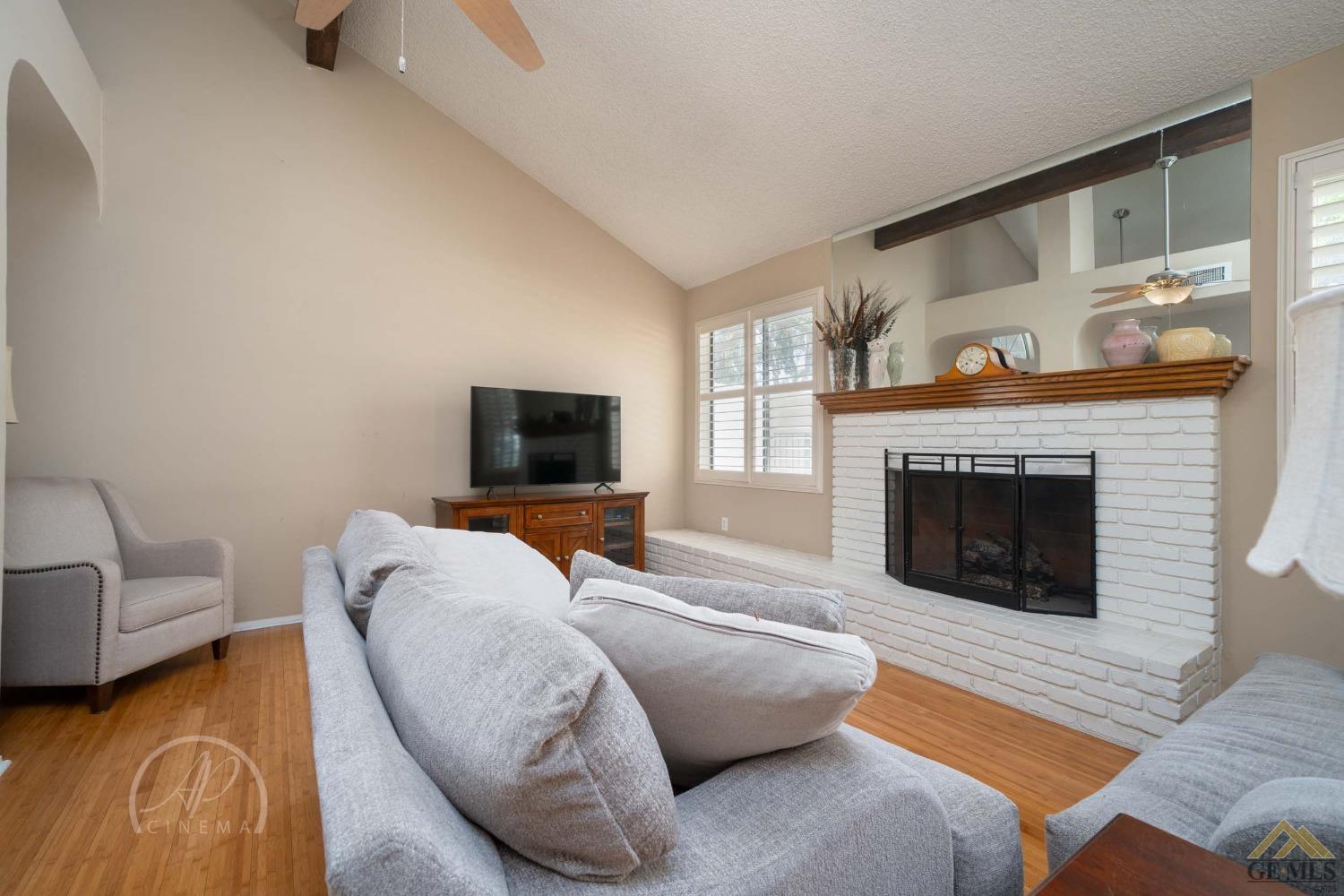 Undisclosed Address Bakersfield, CA 93309 - Photo 6 of 26 a living room with furniture and a fireplace