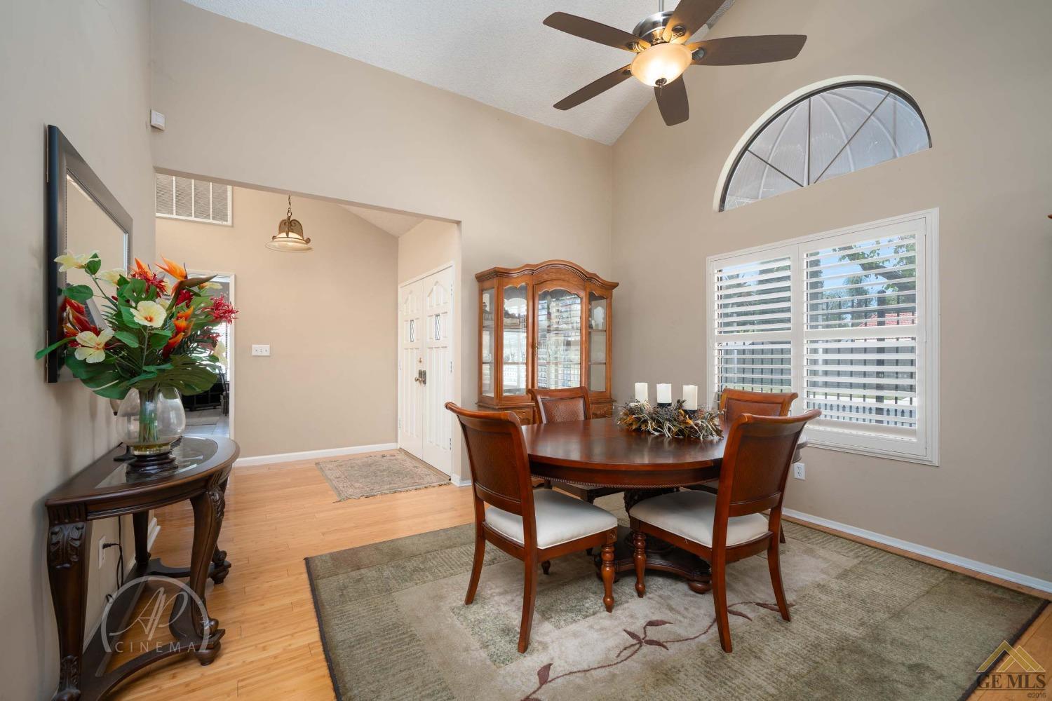 Undisclosed Address Bakersfield, CA 93309 - Photo 9 of 26 a dining room with furniture potted plants and wooden floor
