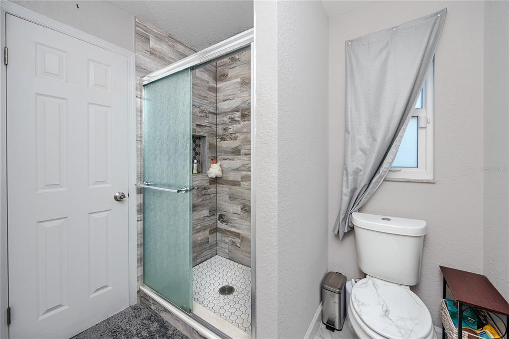 1869 Seton Drive Clearwater, FL 33763 - Photo 15 of 40 a bathroom with a toilet and a shower