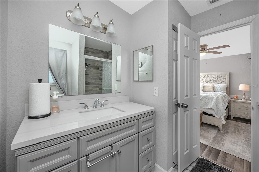 1869 Seton Drive Clearwater, FL 33763 - Photo 19 of 40 a en suite bathroom with a granite countertop sink and a mirror