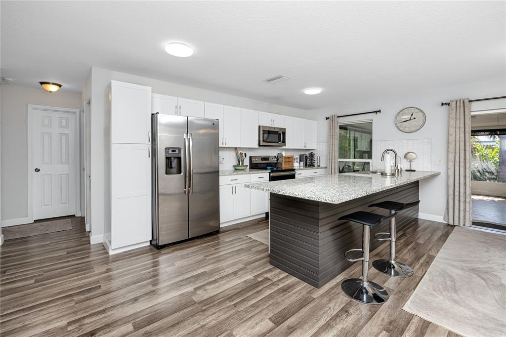 1869 Seton Drive Clearwater, FL 33763 - Photo 7 of 40 a kitchen with a refrigerator and a stove top oven