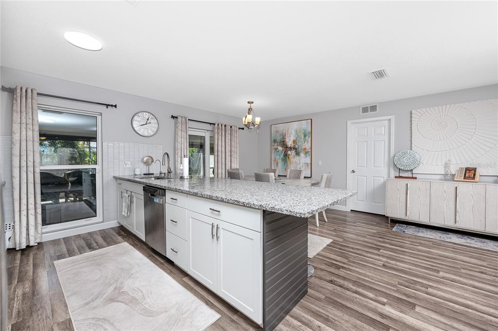 1869 Seton Drive Clearwater, FL 33763 - Photo 8 of 40 a large kitchen with cabinets and wooden floor