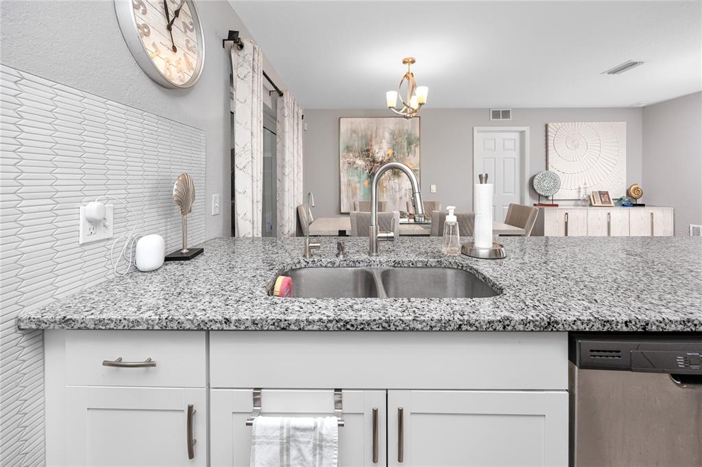 1869 Seton Drive Clearwater, FL 33763 - Photo 9 of 40 a bathroom with kitchen island granite countertop a sink and a white cabinets