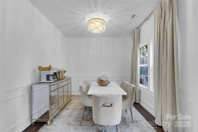 a view of kitchen filled with furniture and wooden floor