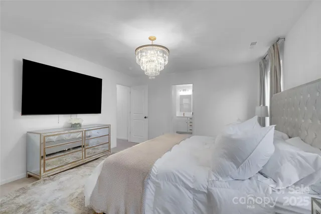 a bedroom with a flat screen television and a bed