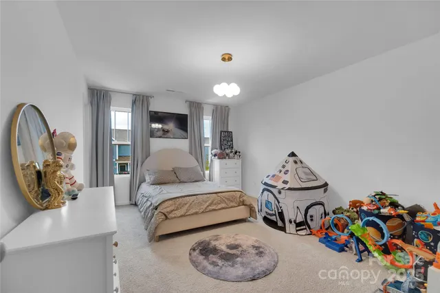 a bedroom with furniture and a wooden floor