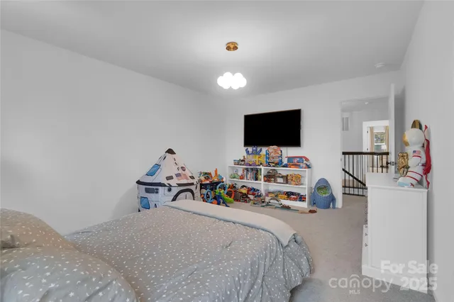a bedroom with furniture and a flat screen tv